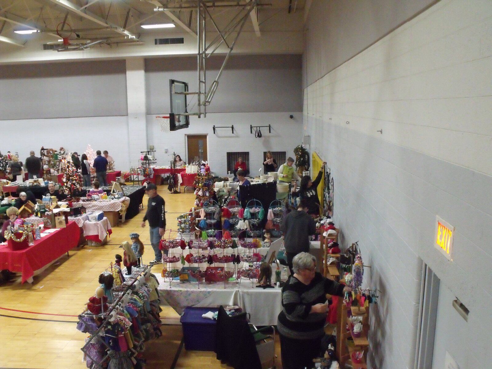 Crafters' tables of ornaments, wreaths and gifts line the CRAF Center gym
