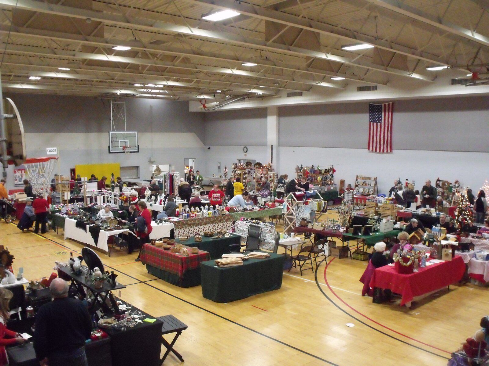 Shoppers browse rows of handmade-gift booths in the CRAF Center gym